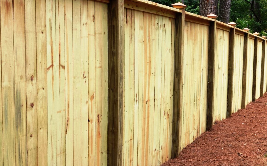 Wood privacy fence with copper cap and trim